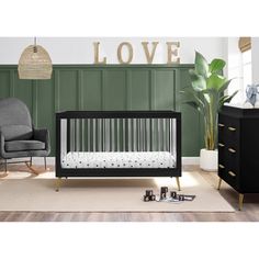 a baby crib in the corner of a room with green walls and white carpet