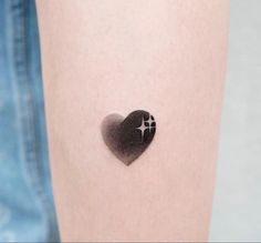 a heart shaped tattoo with a cross on it's left side, in the shape of a heart