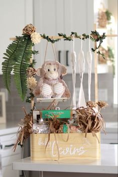 Baby box with monkey on a swing, onesies and other misc gifts. Jungle themed with ivy and neutral floral embellishments. Newborn Baby Gift Basket, Gender Neutral Baby Shower Gifts, Creative Gift Baskets, Baby Shower Baskets, Neutral Baby Gifts, Baby Shower Crafts, Baby Shower Gift Basket, Baby Gift Hampers