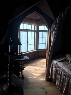 a room with a bed, lamp and window in it's centerpieces