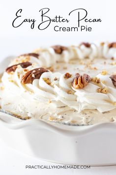 a cake with white frosting and pecans on top is in a pie pan