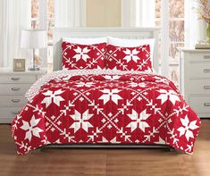 a red and white quilted bedspread with snowflakes on it