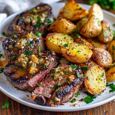 steak and potatoes on a plate with parsley sprinkled on the top, ready to be eaten