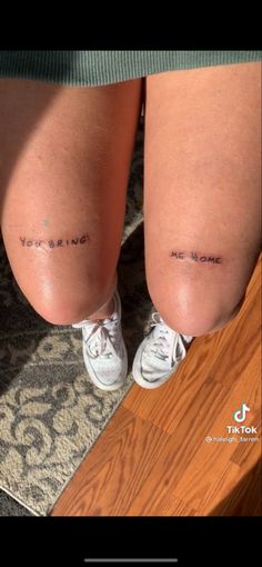 two people with tattoos on their legs and one has the word love written on it