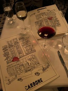 a table topped with wine glasses and menus