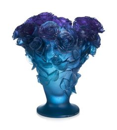 a blue vase filled with lots of purple flowers