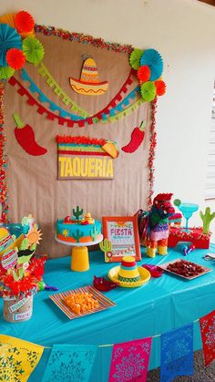 a mexican themed birthday party with tacos, cake and desserts on the table