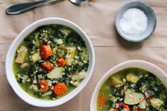 two bowls of vegetable soup on a table