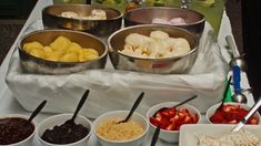 bowls of fruit and ice cream on a table