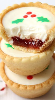 three cookies with icing and candy on them are stacked up next to each other