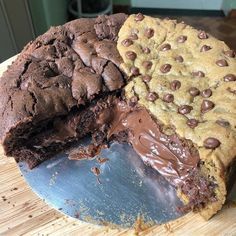 two chocolate cookies and one cookie cake on a cutting board