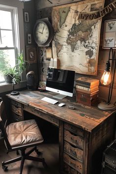 an old world map hangs on the wall behind a desk with a computer and chair