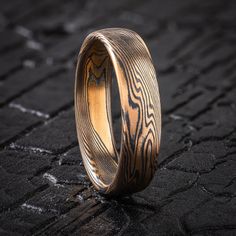 "* Price may vary depending on ring size, please inquire with us directly with your needed size for accurate pricing! This rustic 6mm Mokume Gane ring is shown in the Twist pattern and Spark palette, with a Low Dome profile. It also has an etched & oxidized finish to showcase the layers and bold pattern. The Spark palette features 14k Yellow Gold and Sterling Silver. Pattern: Twist Palette: Spark Finish: Etched & Oxidized Profile: Low Dome  Width Shown: 6mm Size Shown: 12 Price does NOT include stones or setting fees. We care about customer service and would like to hear from you! Please contact us to help create your treasured item, we take your concerns and requests to heart and will work together to create your unique designs SPECIAL PRICING FOR SETS. CONTACT US WITH YOUR DESIRED WIDTHS Mokume Gane Ring, Twist Pattern, Mokume Gane, The Spark, Large Ring, Small Rings, Solid Metal, Gold Style, Silver Band