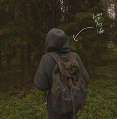 a person with a backpack walking in the woods