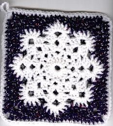 a crocheted square with black and white squares