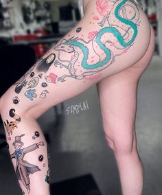 a woman's legs with tattoos on them