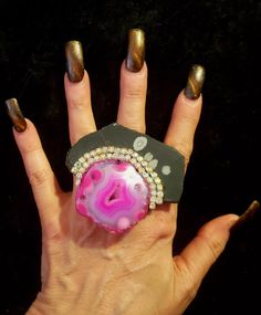 Here is a gorgeous pink druzy agate and snowflake jasper slab Statement Ring, unworn, from my personal collection. This Art Deco inspired Cocktail Ring measures 3" x 2.75" and shows a high end hot pink druzy agate mounted onto a black snowflake jasper slab accented with silver Aurora Borealis Rhinestones. This piece of sexy jewelry is pure glamour and made for most with a silvertone adjustable mount that will adjust to fit nearly all. This OOAK and unique ring is from the Atelier of Kat Kouture! Unique Adjustable Crystal Ring With Stones, Unique Agate Crystal Ring For Gift, Unique Agate Crystal Ring Gift, Unique Crystal Ring With Large Stone, Unique Pink Rings With Large Stone, Luxury Statement Crystal Gemstone Ring, Unique Large Stone Geodes As Gift, Unique Agate Geodes For Gift, Unique Agate Geodes