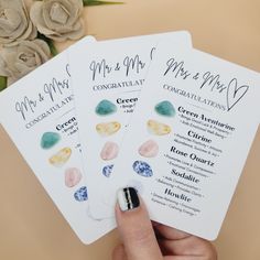 three wedding program cards held in their hand