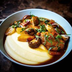 a white bowl filled with food on top of a table