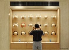 a man standing in front of a display of headphones