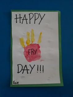 a child's handprinted sign on a blue wall reads happy fry day