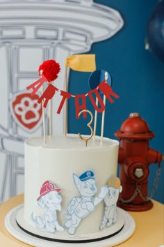 a white cake with red and blue decorations