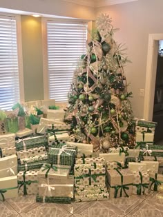 a christmas tree is surrounded by many wrapped presents