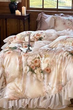 the comforter is made up with ruffles and flowers on it's bed