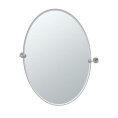 an oval mirror with two handles on the wall