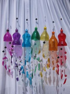 there are many different colored bottles hanging from the curtain