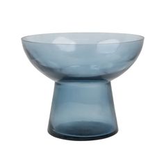 a blue glass bowl sitting on top of a table