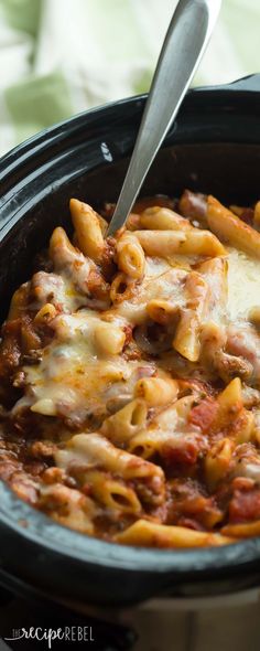 a crock pot filled with pasta and meat