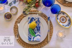 a place setting with blue and yellow plates