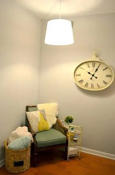 a room with a chair and clock on the wall