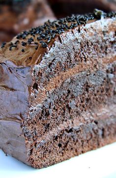 a piece of chocolate cake sitting on top of a white plate