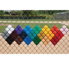 a baseball field behind a chain link fence with colored squares in the center and bottom half