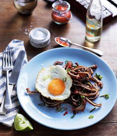 an egg is sitting on top of some noodles