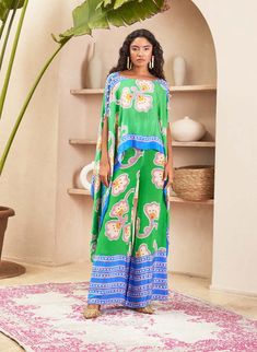 Introducing the co-ord set, where contemporary design meets meticulous detailing. The straight pants are adorned with a carefully placed border, adding a subtle yet stylish touch. The kaftan-style ... Silk Sets With Printed Motifs In Maxi Length, Silk Maxi Sets With Printed Motifs, Chic Green Floral Print Sets, Festive Green Printed Kaftan, Spring Green Kaftan With Printed Motifs, Green Silk Palazzo Set With Printed Motifs, Green Floral Print Maxi Set, Green Floral Print Maxi Length Set, Summer Sets With Printed Motifs And Maxi Length