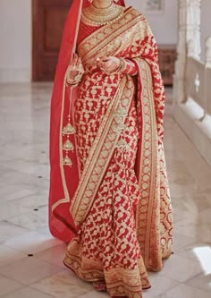 a woman in a red and gold bridal gown