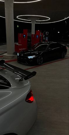 two cars parked in a parking garage at night