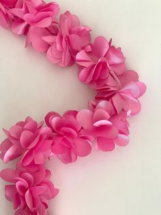 pink flowers are arranged on a white surface