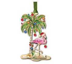 a christmas ornament with a pink flamingo sitting on a chair under a palm tree