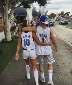 two basketball players walking down the street with their arms around each other