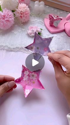 someone is making a paper star decoration