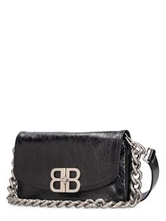 Find BALENCIAGA Small Bb Soft Leather Shoulder Bag on Editorialist. This BALENCIAGA shoulder bag features a turn-lock closure, metal logo detail, silver-colored metal hardware, and one internal zip pocket. The bag measures 10cm in height, 20cm in width, and 5cm in depth. It includes a detachable, adjustable strap and a metal chain top handle. The bag can be worn on the shoulder or crossbody. Balenciaga Top, Balenciaga Women, Chain Top, Ski Accessories, Metal Logo, Swim Accessories, Heeled Loafers, Metallic Logo, Metal Hardware