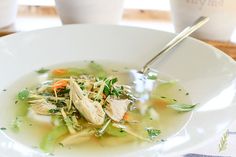 a white bowl filled with soup on top of a table