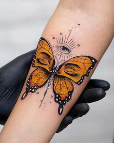 a woman's arm with a butterfly tattoo on it