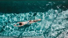 an aerial view of a man swimming in the ocean