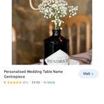 an image of a vase with flowers in it on the web page for wedding table name