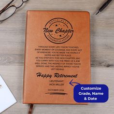 a personalized leather notebook with the words happy retirement and date on it next to glasses